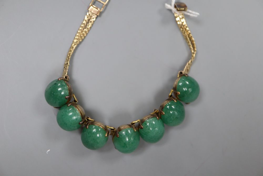 A 14k yellow metal and simulated cabochon jade set bracelet, 18.3cm, gross 33.4 grams.